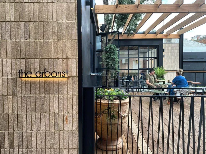 Vertical brick cladding beside The Arborist signage on the rooftop terrace in Geelong