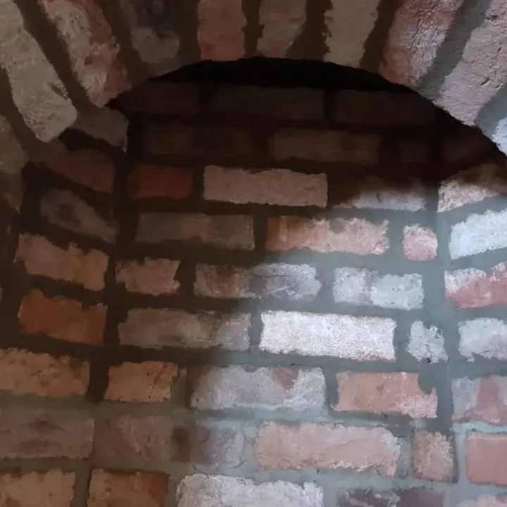 Interior arched brick recess with a curved brick arch and exposed face brickwork